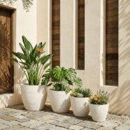 Luxury white round planters styled on a sunlit modern patio