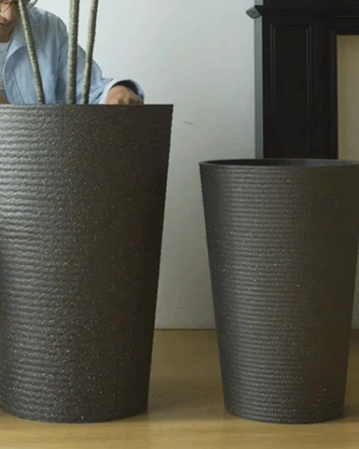 gallery-black-tall-planter-detail Detailed view of a black stone textured tall round planter