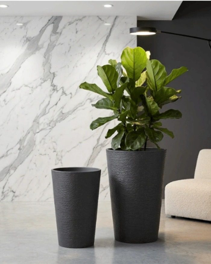 gallery-black-tall-planter-living-space Black stone textured tall round planter styled in a modern living space