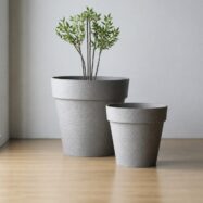 Jumbo and Super Jumbo light gray raised-rim planters in a minimalist studio