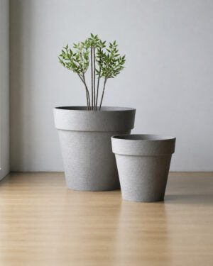 Jumbo and Super Jumbo light gray raised-rim planters in a minimalist studio