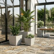Light gray square planters styled in a bright conservatory
